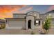 Charming two-story home with an attached two-car garage and desert landscaping against a vibrant sky at 3944 E Ghost Flower Ln, San Tan Valley, AZ 85140