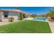 Backyard with pool, artificial turf, and desert landscaping at 40913 W Williams Way, Maricopa, AZ 85138