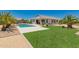 Spacious backyard with pool, artificial turf, and mature palm trees at 40913 W Williams Way, Maricopa, AZ 85138