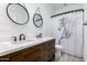 Modern bathroom with a double sink vanity, white countertops, and horse-themed shower curtain at 40913 W Williams Way, Maricopa, AZ 85138
