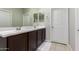 Bathroom with a double sink vanity, tile flooring, and a large mirror at 40913 W Williams Way, Maricopa, AZ 85138