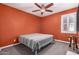 Cozy bedroom featuring a ceiling fan, shutters, and a colorful bedspread at 40913 W Williams Way, Maricopa, AZ 85138