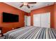 Cozy bedroom with a ceiling fan, tv, and a closet at 40913 W Williams Way, Maricopa, AZ 85138