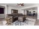 Comfortable living room featuring a ceiling fan, open floor plan, wood-look floors and a built-in bar at 40913 W Williams Way, Maricopa, AZ 85138