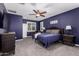 Spacious main bedroom featuring a ceiling fan, shutters, carpet, and comfortable furnishings at 40913 W Williams Way, Maricopa, AZ 85138