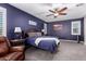 Spacious main bedroom with a ceiling fan, shutters, carpet, and a leather reading chair at 40913 W Williams Way, Maricopa, AZ 85138