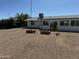 Wide backyard featuring gravel, planter blocks, a tree and home at 433 S 113Th Pl, Mesa, AZ 85208