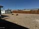 Spacious backyard with gravel landscaping, storage shed and privacy fence at 433 S 113Th Pl, Mesa, AZ 85208