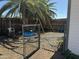 Fenced backyard with large shade tree, gravel landscaping and swing set at 433 S 113Th Pl, Mesa, AZ 85208