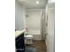 Bathroom showing tiled shower/tub combo, toilet, and stylish vanity with gold hardware at 433 S 113Th Pl, Mesa, AZ 85208