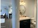 View of bathroom featuring modern vanity, gold fixtures, and mirror from living room at 433 S 113Th Pl, Mesa, AZ 85208