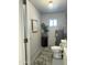 Utility room with compact toilet, water heater, and storage; great potential at 433 S 113Th Pl, Mesa, AZ 85208