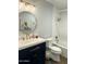 Bathroom featuring stylish vanity with gold fixtures, mirror, and tiled shower/tub combo at 433 S 113Th Pl, Mesa, AZ 85208