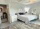 Airy bedroom with a queen bed, rug, and open access to the en-suite bathroom at 433 S 113Th Pl, Mesa, AZ 85208