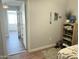 Bedroom with wood look floors, light gray walls, and view to hallway with open door at 433 S 113Th Pl, Mesa, AZ 85208
