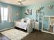 Bedroom with white daybed, white rug, light blue walls, and view into hallway at 433 S 113Th Pl, Mesa, AZ 85208