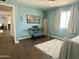 Bedroom with wood look floors, light blue walls, piano, and large windows at 433 S 113Th Pl, Mesa, AZ 85208