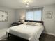 Calming bedroom with a ceiling fan, large window, and modern decor at 433 S 113Th Pl, Mesa, AZ 85208