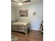 Cozy bedroom featuring stylish decor, wood floors and a comfortable bed at 433 S 113Th Pl, Mesa, AZ 85208