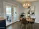 Modern dining room with stylish lighting and french doors leading to the patio at 433 S 113Th Pl, Mesa, AZ 85208