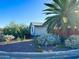 Quaint single story home with desert landscaping, and mature palm tree on a sunny day at 433 S 113Th Pl, Mesa, AZ 85208