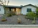 Charming single story home with gravel landscaping and a decorative white border at 433 S 113Th Pl, Mesa, AZ 85208