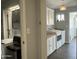 Functional laundry room with overhead cabinets, butcher block countertops, modern washer and dryer, and wood look floors at 433 S 113Th Pl, Mesa, AZ 85208