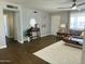 Open living room featuring wood floors, modern ceiling fan, and lots of natural light at 433 S 113Th Pl, Mesa, AZ 85208