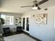 Sun room featuring sliding doors, ceiling fan, decor art and modern furniture at 433 S 113Th Pl, Mesa, AZ 85208