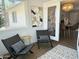 Light-filled sun room with view to dining room, comfortable seating and stylish decor at 433 S 113Th Pl, Mesa, AZ 85208