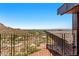 Balcony features a steel railing and faces a view of the valley and distant mountain range at 4925 E Red Rock Dr # 43, Phoenix, AZ 85018