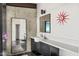 Modern bathroom features a large mirror, sleek vanity, and unique clock detail at 4925 E Red Rock Dr # 43, Phoenix, AZ 85018