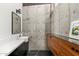 Modern bathroom features unique concrete wall, sleek vanity, and custom cabinets at 4925 E Red Rock Dr # 43, Phoenix, AZ 85018