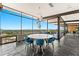 Stylish dining room with blue chairs and a large window showcasing a breathtaking city view at 4925 E Red Rock Dr # 43, Phoenix, AZ 85018