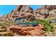 Striking desert home with glass walls and stone accents, set against a dramatic red rock mountain backdrop at 4925 E Red Rock Dr # 43, Phoenix, AZ 85018