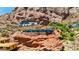 Contemporary house features glass walls and stonework blending seamlessly with the rugged red rock terrain at 4925 E Red Rock Dr # 43, Phoenix, AZ 85018