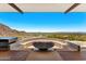 Inviting fire pit area with built-in seating, creating a cozy outdoor gathering space with city views at 4925 E Red Rock Dr # 43, Phoenix, AZ 85018