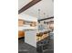 Gourmet kitchen featuring wood cabinets, stainless hood, and large center island with bar stool seating at 4925 E Red Rock Dr # 43, Phoenix, AZ 85018