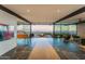 Open living room with stunning city views through expansive windows, leading to an outdoor fire pit at 4925 E Red Rock Dr # 43, Phoenix, AZ 85018