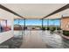 Bright living room featuring stone floors, modern furniture, and large sliding glass doors at 4925 E Red Rock Dr # 43, Phoenix, AZ 85018