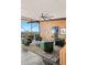 Stylish living room features swivel chairs, unique ceiling fan, and expansive windows with a stunning view at 4925 E Red Rock Dr # 43, Phoenix, AZ 85018
