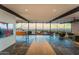 Open living room with stunning city views through expansive windows, leading to an outdoor fire pit at 4925 E Red Rock Dr # 43, Phoenix, AZ 85018