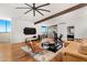 Open living room with hardwood floors, beamed ceilings, modern furniture, and exercise equipment at 4925 E Red Rock Dr # 43, Phoenix, AZ 85018