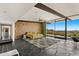Bright main bedroom featuring floor-to-ceiling windows, hardwood accent wall, and modern finishes at 4925 E Red Rock Dr # 43, Phoenix, AZ 85018
