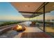 An incredible covered patio with fireplace, lounge chairs, and stunning city views at 4925 E Red Rock Dr # 43, Phoenix, AZ 85018