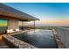 Stunning pool with stone surround, lounge chairs and breathtaking city views at 4925 E Red Rock Dr # 43, Phoenix, AZ 85018