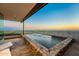 Infinity pool with stone surround and stunning city views beyond the patio at 4925 E Red Rock Dr # 43, Phoenix, AZ 85018