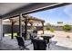 Back patio featuring a jacuzzi, pergola, fire pit, and outdoor seating area at 6802 S 44Th Pl, Phoenix, AZ 85042