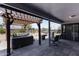 Covered back patio featuring a jacuzzi, outdoor grill, and comfortable seating area at 6802 S 44Th Pl, Phoenix, AZ 85042
