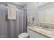 Bathroom features a shower with a light grey shower curtain at 6802 S 44Th Pl, Phoenix, AZ 85042